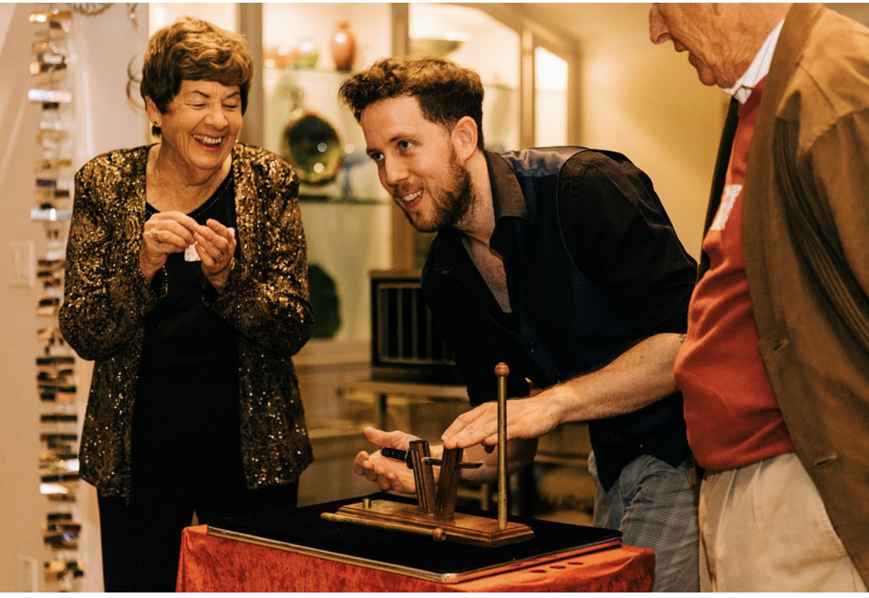 best magician for holiday events in Long Beach performing an amazing stand up piece of magic.